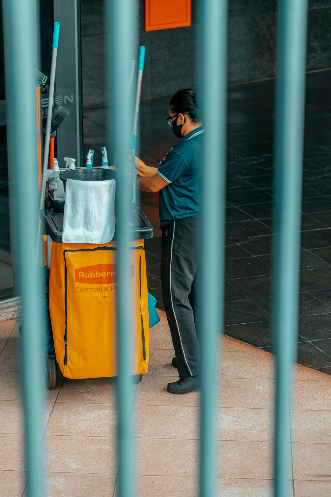 A man cleaning skyscraper windows with a harness, showcasing urban high-rise work.